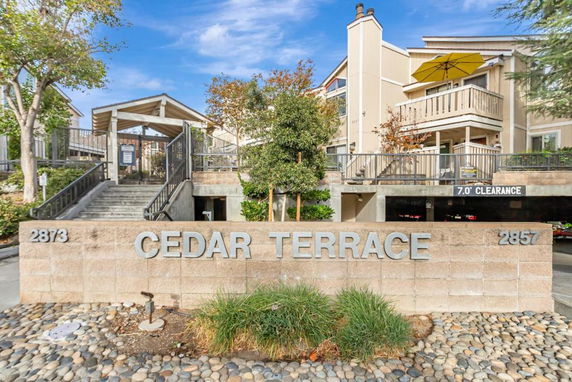 Front view of a residential building with an entrance and signage reading Cedar Terrace.