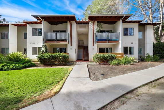 Front view of a two-story apartment building with balconies.
