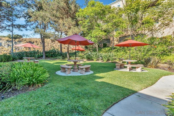 Garden area with picnic tables and umbrellas.