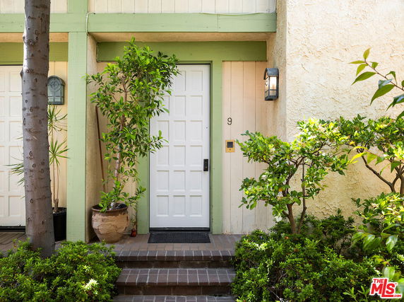 Front view of a house entrance with a white door and green trim.