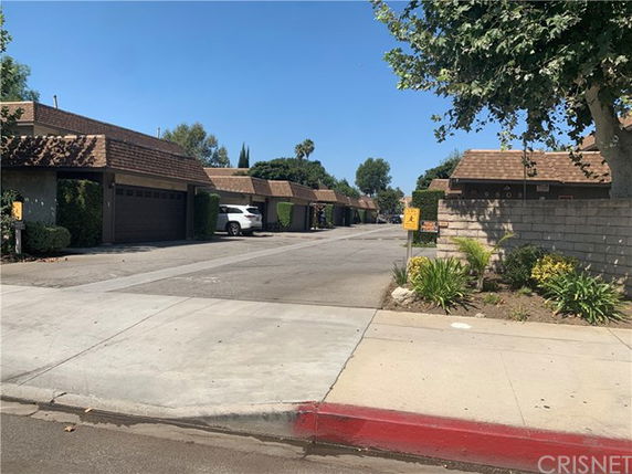 Row of townhouses with garages viewed from the street.