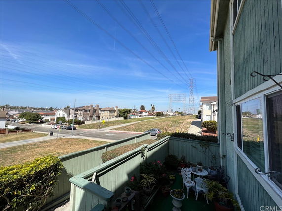 View from a building balcony overlooking surrounding houses and power lines.