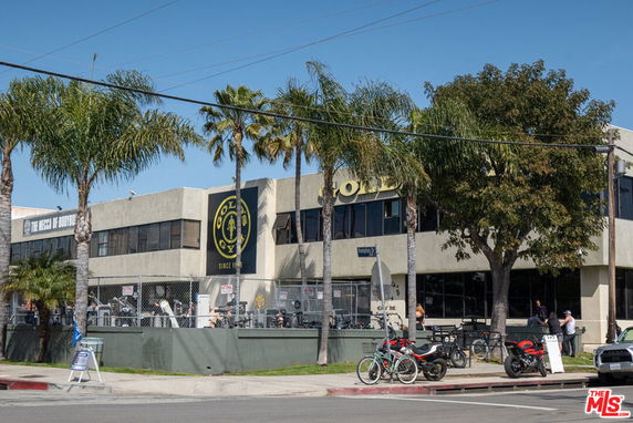 Front view of a two-story gym building with large windows.