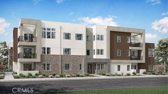 Front view of a modern multi-story apartment building with balconies.
