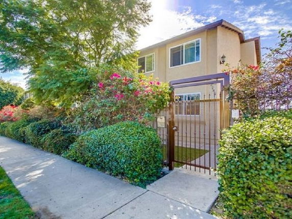 Front view of a two-story house with a gated entrance.