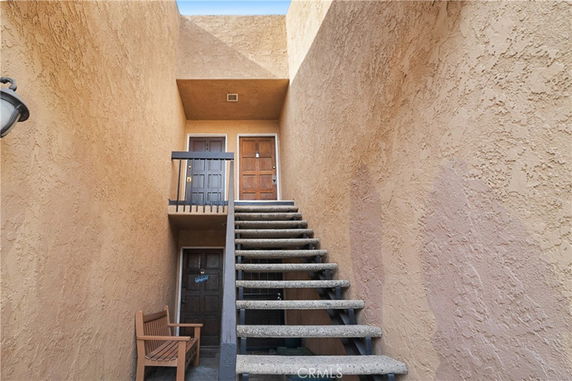 Staircase leading to the entrance of a building with two doors, one on each level.