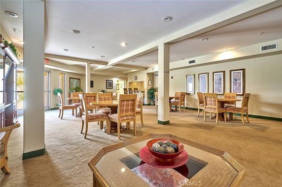 Interior of a recreation room with tables and chairs for socializing.