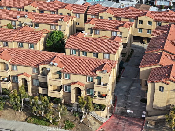 Elevated view of a multi-story residential complex with red tiled roofs.