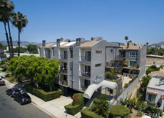 Front view of a multi-story apartment building with balconies.