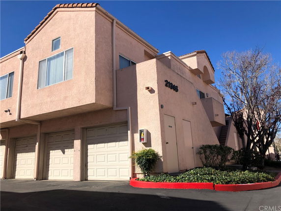 Front view of a multi-story building with a garage.