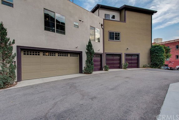 Front view of a multi-story house with multiple garages.