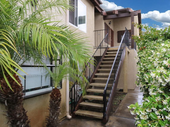 View of an exterior staircase leading to the upper level of a building.