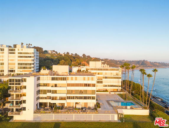 Front view of a multi-story building near the coastline.