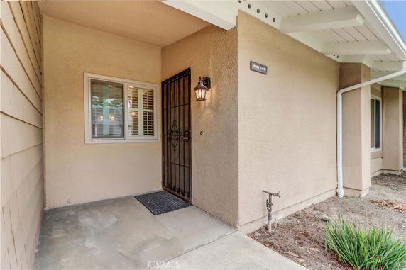 Entrance of a house with a front door and a window nearby.