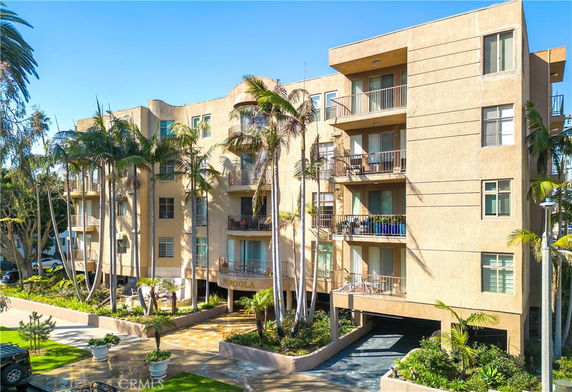 Front view of a multi-story apartment building with balconies.