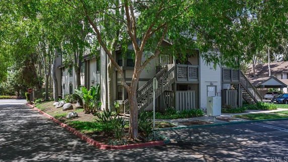 Front view of a two-story apartment building with external staircases.