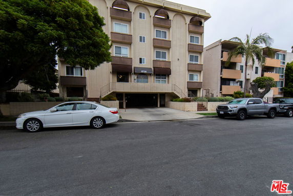 Front view of a multi-story residential building with balconies.