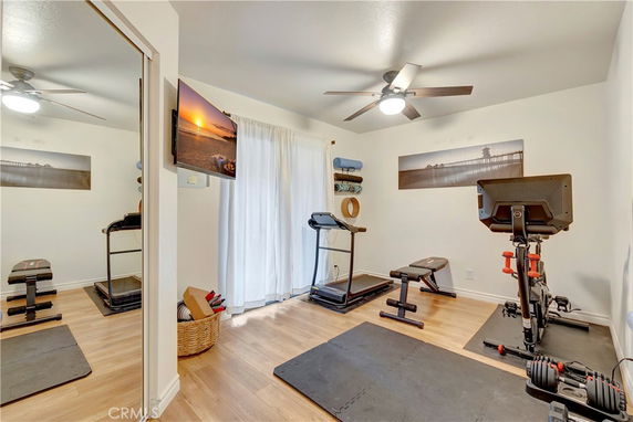 Indoor gym area with exercise equipment and wall-mounted art.