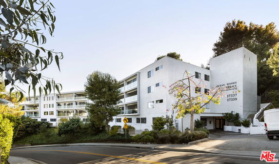 Front view of a multi-story residential building with balconies.