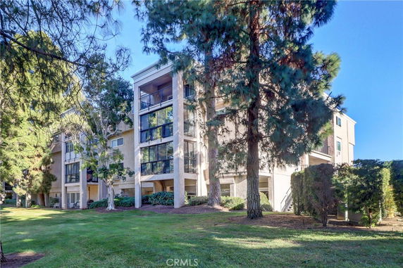 Front view of a multi-story residential building with balconies.