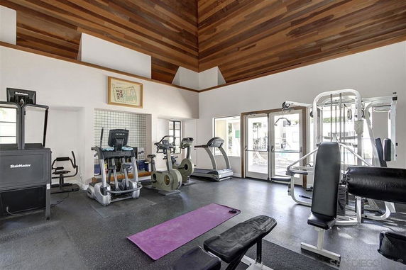 Interior view of a gym area with various exercise equipment.