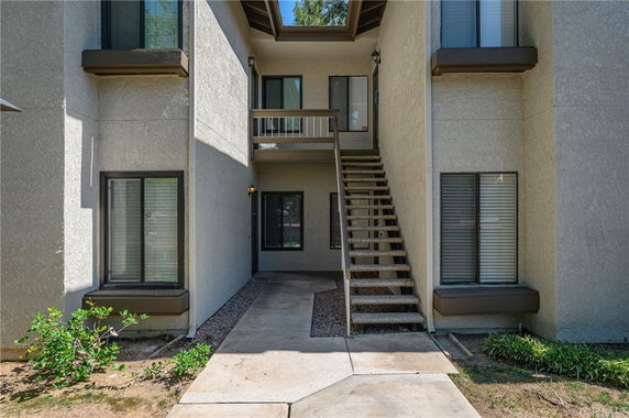 Front view of a building with an outdoor staircase leading to the second floor.