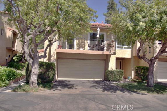 Front view of a two-story house with a double garage and balcony.