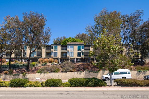 Front view of a multi-story residential building with balconies.