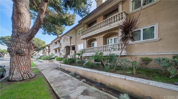 Front view of a multi-story residential building with balconies.