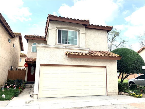 Front view of a two-story house with a garage.