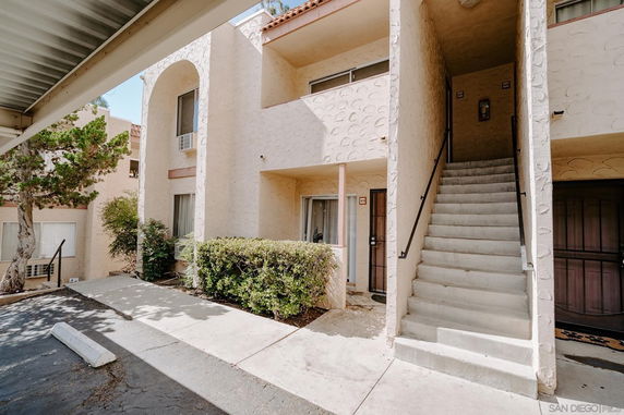 Front view of a two-story apartment building with an outdoor staircase.