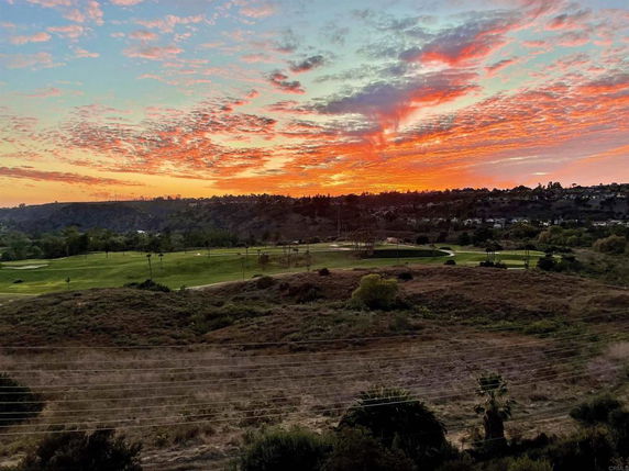 Panoramic view of a landscape with a colorful sunset sky.