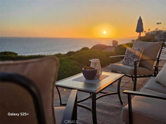 Outdoor seating area overlooking a sunset ocean view.