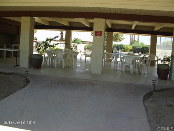 Outdoor covered area with tables and chairs.