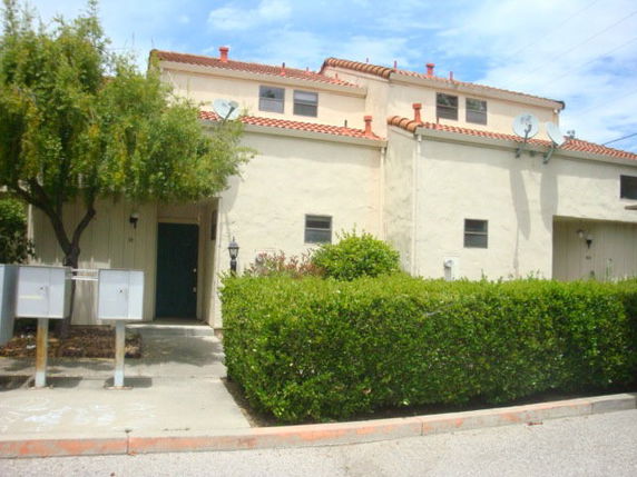 Front view of a two-story house with a tiled roof.