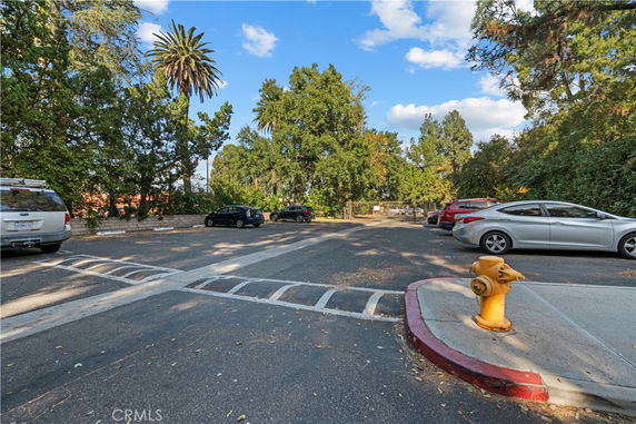 Outdoor parking area with multiple cars and a fire hydrant.