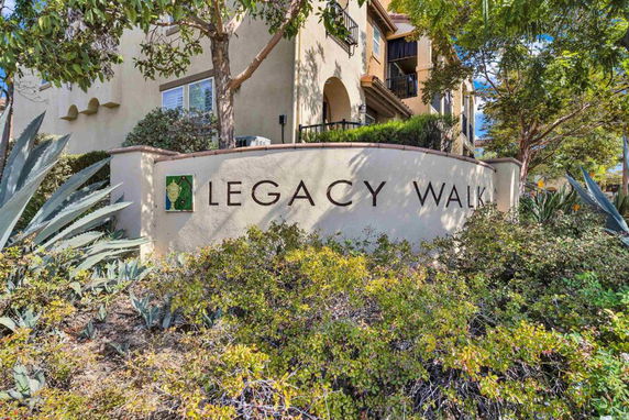 Front view of a residential building with the name 'Legacy Walk' displayed on the wall.