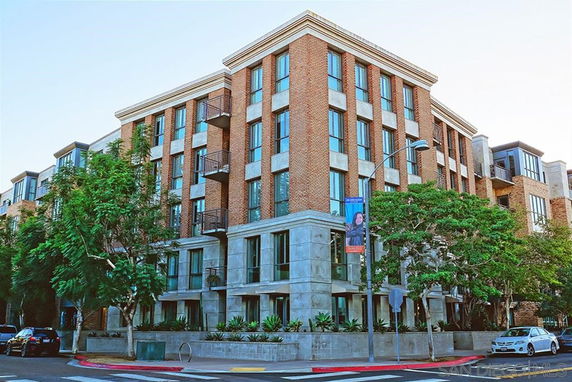Front view of a multi-story building with a brick exterior and modern design.