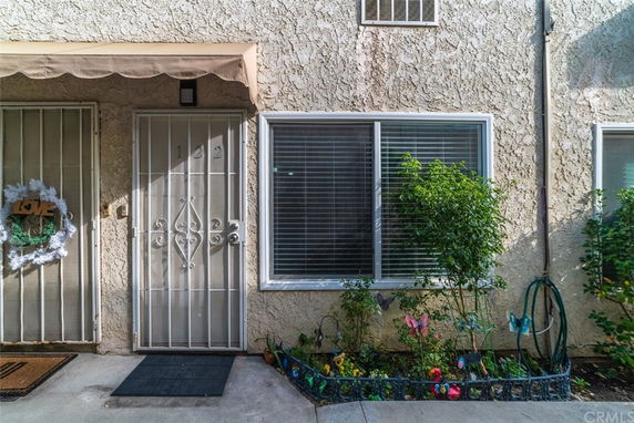 Front view of a building entrance with a security door and window.
