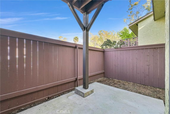 Small fenced outdoor area with an overhanging roof support.