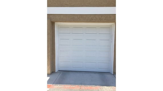 Front view of a building with a single garage door.