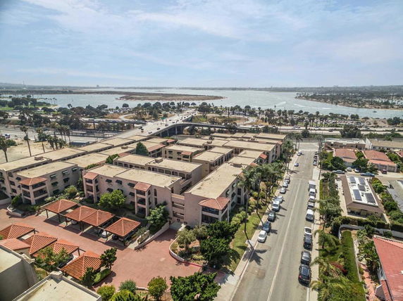 Wide-angle view of a residential area near a large body of water.