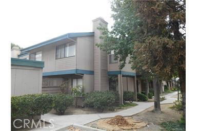 Front view of a two-story building with balconies and a chimney.