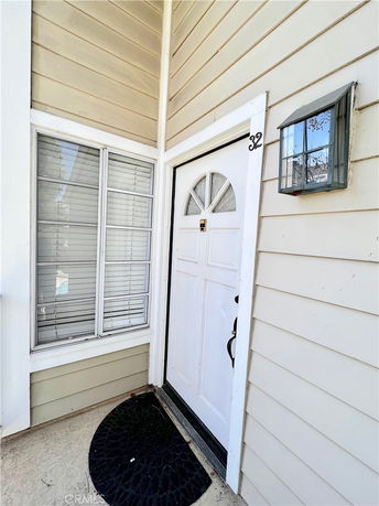 Close-up view of an entrance door with a window beside it.