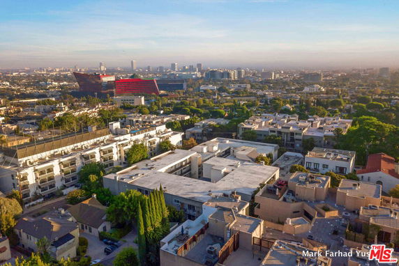 Wide angle view of cityscape with buildings and trees.