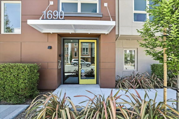 Front view of a building entrance with a canopy and glass door.