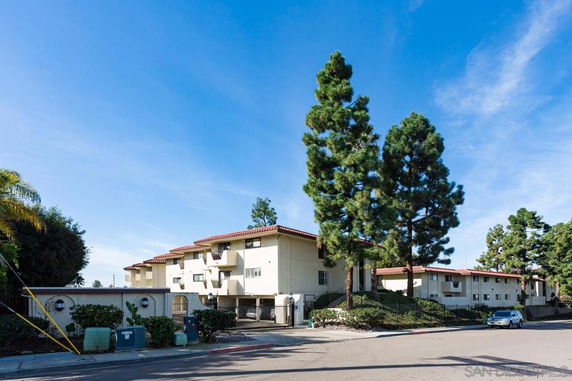 Front view of a multi-story residential building with balconies.