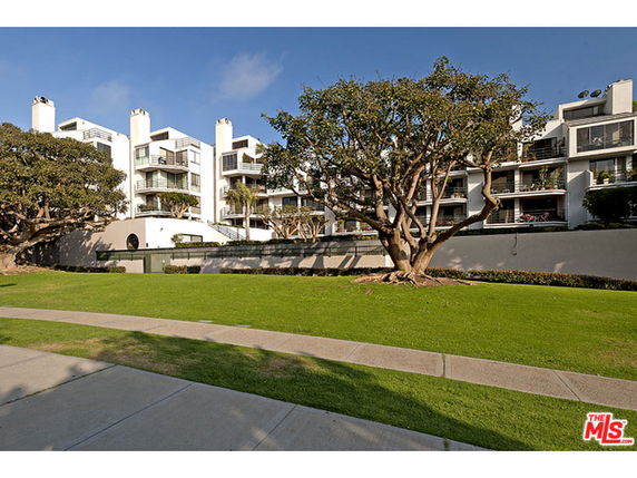 Front view of a multi-story residential building with balconies.