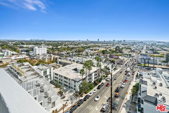 Wide-angle view of urban area with buildings and streets extending into the distance.