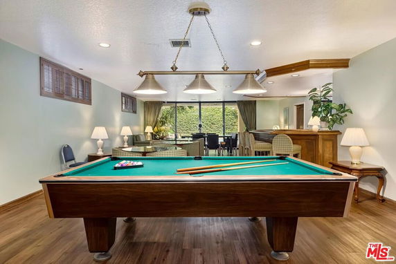 Interior view of a recreational room with a pool table and seating area.